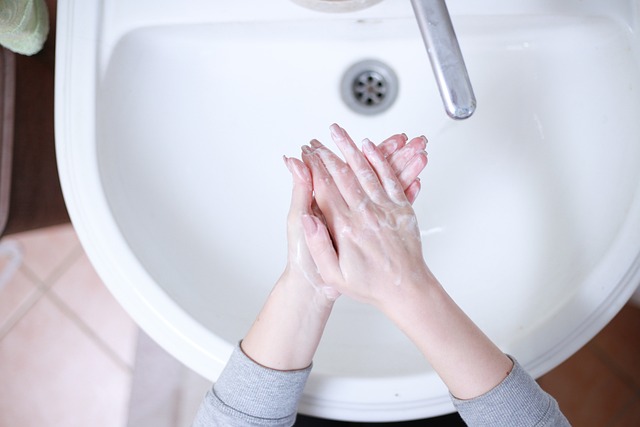 woman washing her hands at sink