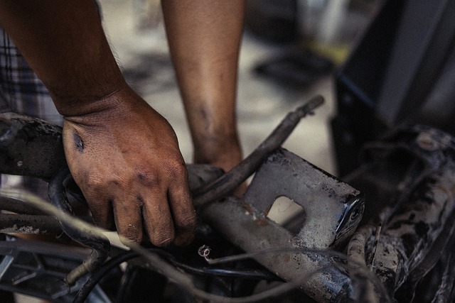 two mechanic hands getting dirty